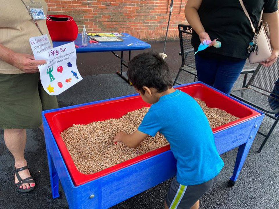 child enjoying diggin in the bean table